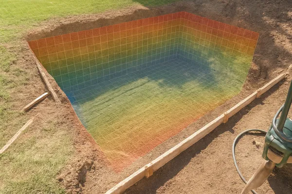 Pool construction professional using Trackmetry for precise pool edge measurements and coping set-out